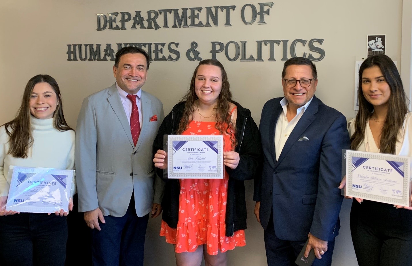 Image of students holding certificates for their achievements